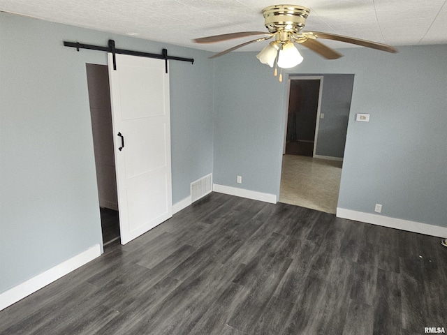 2508 Forest Ave, Mount Vernon, IL 62864 - empty room featuring a ceiling fan, a barn door, and dark wood finished floors