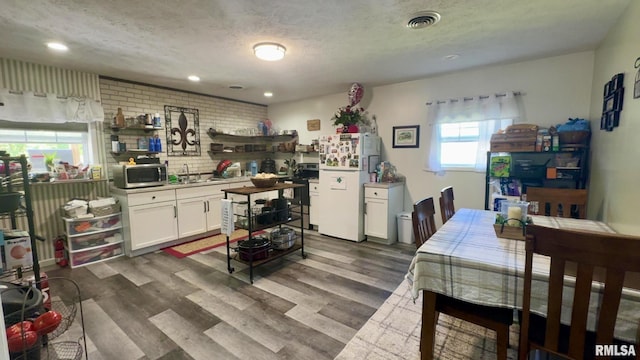 506 S Kentucky St, Benton, IL 62812 - dining space featuring dark wood-style floors, a textured ceiling, and recessed lighting