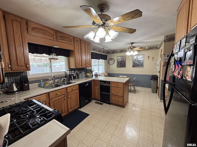 49 Jon St, Metropolis, IL 62960 - kitchen with black appliances, a peninsula, brown cabinetry, light countertops, and light floors