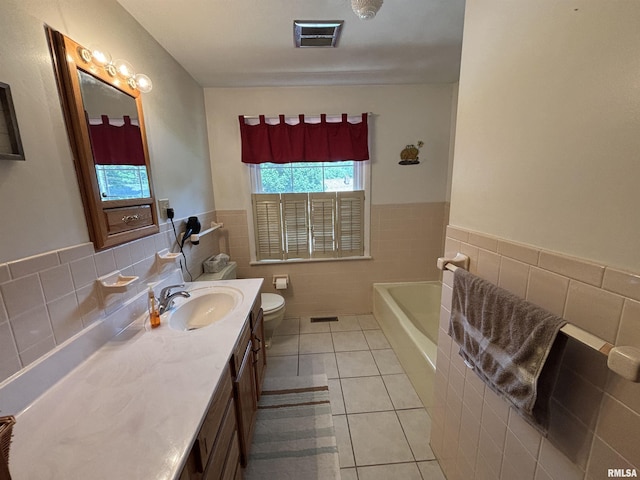 49 Jon St, Metropolis, IL 62960 - bathroom with tile walls, tile patterned flooring, a tub, vanity, and a wainscoted wall