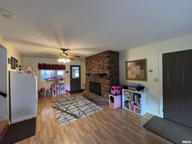 49 Jon St, Metropolis, IL 62960 - living area with wood finished floors, ceiling fan, and a brick fireplace