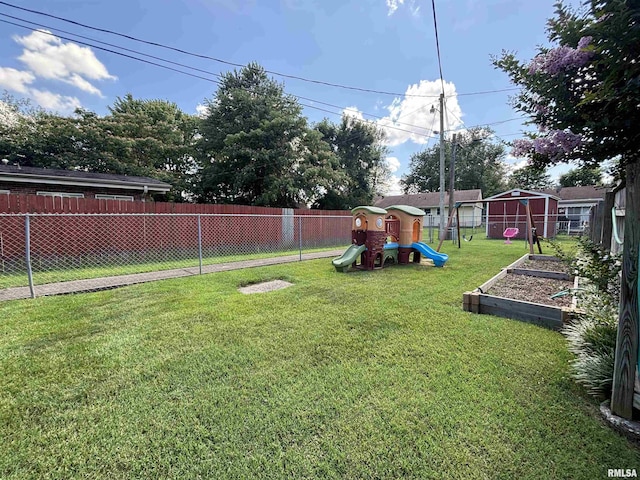 49 Jon St, Metropolis, IL 62960 - fenced backyard featuring a playground and a vegetable garden