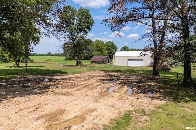 18640 Mount Zion Rd, Benton, IL 62812 - view of green lawn with a detached garage, an outbuilding, dirt driveway, and a pole building