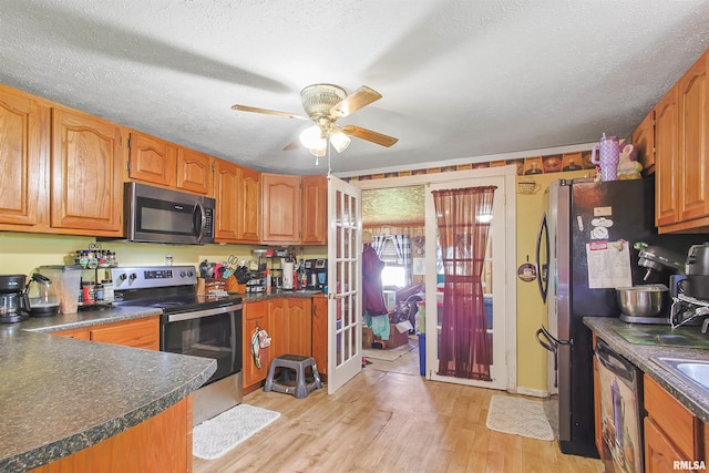 735 Sharp Rd, Anna, IL 62906 - kitchen featuring appliances with stainless steel finishes, dark countertops, a ceiling fan, light wood-style floors, and a textured ceiling
