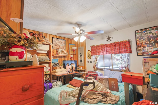 735 Sharp Rd, Anna, IL 62906 - bedroom with a textured ceiling, electric panel, wooden walls, and a ceiling fan