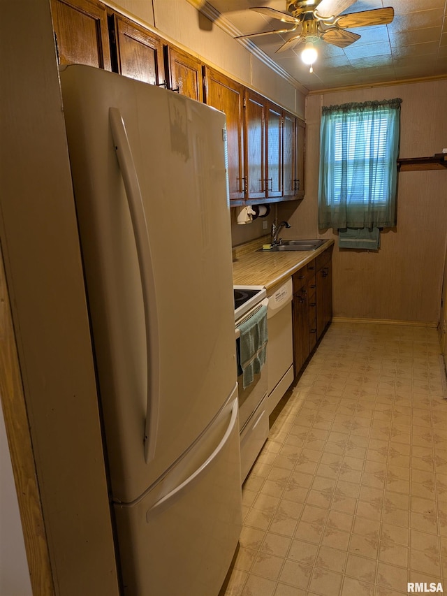 1205 Burgess Ave, Johnston City, IL 62951 - kitchen with white appliances, light flooring, ceiling fan, light countertops, and brown cabinetry