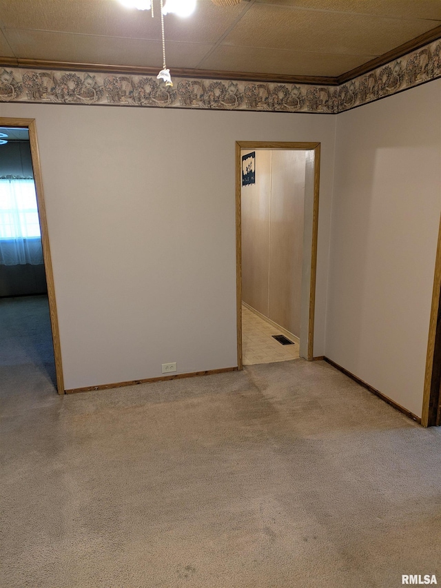 1205 Burgess Ave, Johnston City, IL 62951 - spare room featuring light colored carpet and crown molding