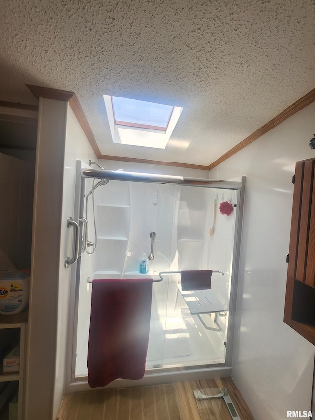 8747 Old State Route 14th Rte, Duquoin, IL 62832 - bathroom featuring ornamental molding, a skylight, a textured ceiling, a stall shower, and wood finished floors