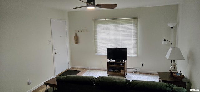 308 Blossom St, Carterville, IL 62918 - living room featuring a ceiling fan, a baseboard heating unit, and wood finished floors