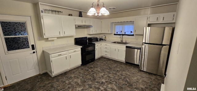 308 Blossom St, Carterville, IL 62918 - kitchen with appliances with stainless steel finishes, under cabinet range hood, light countertops, white cabinets, and a chandelier