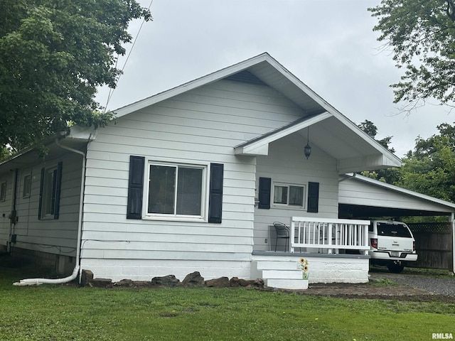 308 Blossom St, Carterville, IL 62918 - view of front of house featuring a front yard and an attached carport