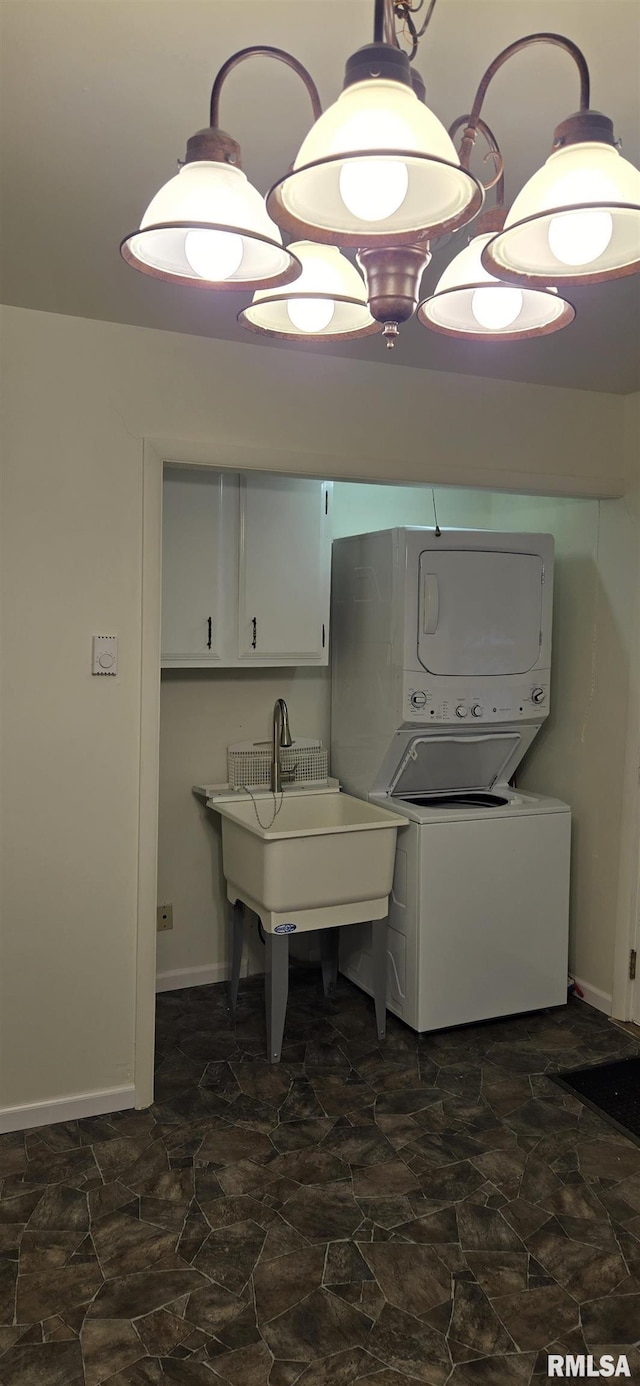 308 Blossom St, Carterville, IL 62918 - laundry room featuring cabinet space, stacked washing machine and dryer, and stone finish flooring