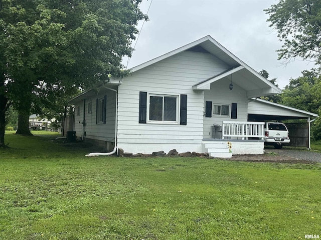 308 Blossom St, Carterville, IL 62918 - view of front of property featuring a carport, a front lawn, and gravel driveway