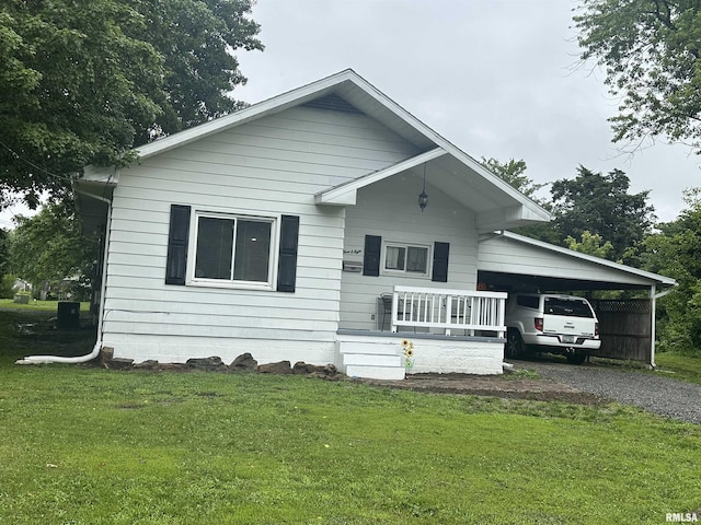 308 Blossom St, Carterville, IL 62918 - bungalow-style house featuring driveway, a front yard, and an attached carport