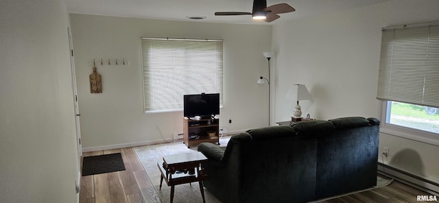 308 Blossom St, Carterville, IL 62918 - living area featuring a baseboard radiator, ceiling fan, and wood finished floors