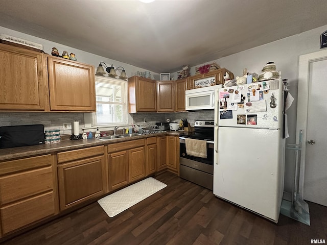 525 N St, Murphysboro, IL 62966 - kitchen with white appliances, dark wood finished floors, decorative backsplash, dark countertops, and brown cabinets
