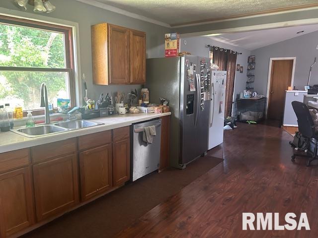 1011 S 20th St, Murphysboro, IL 62966 - kitchen featuring stainless steel appliances, dark wood finished floors, brown cabinets, light countertops, and lofted ceiling