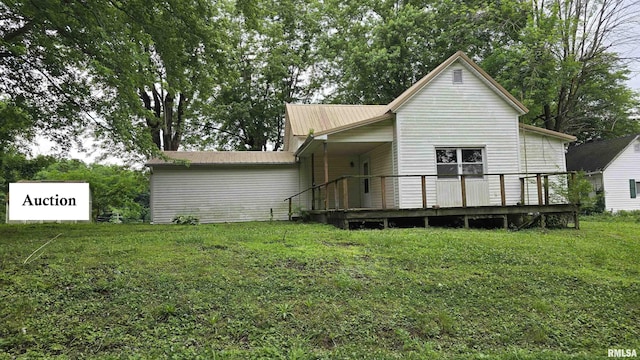 711 Mclean St, Rosiclare, IL 62982 - rear view of property featuring a yard, a deck, and a metal roof