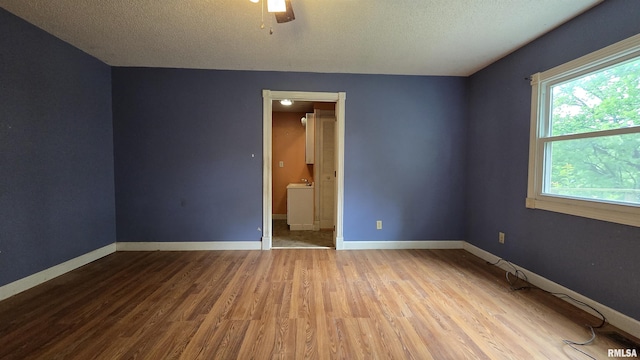 711 Mclean St, Rosiclare, IL 62982 - unfurnished room featuring wood finished floors, a textured ceiling, and ceiling fan