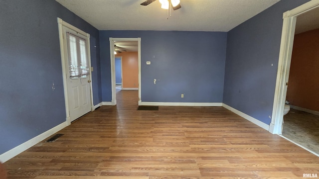 711 Mclean St, Rosiclare, IL 62982 - spare room with ceiling fan, wood finished floors, and a textured ceiling