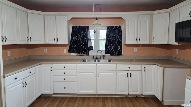 711 Mclean St, Rosiclare, IL 62982 - kitchen featuring white cabinetry, black microwave, pendant lighting, and dark wood-style floors