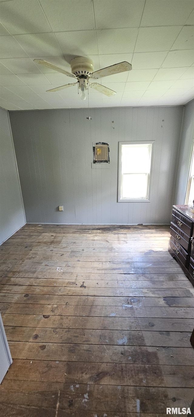 4801 Quail Run Rd, Salem, IL 62881 - empty room featuring hardwood / wood-style flooring, ceiling fan, wood walls, and an AC wall unit