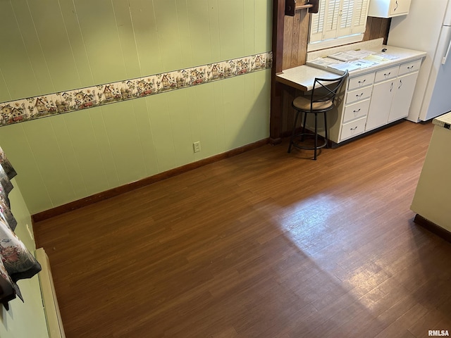1026 E Noleman St, Centralia, IL 62801 - kitchen featuring white cabinetry, dark wood finished floors, light countertops, and freestanding refrigerator