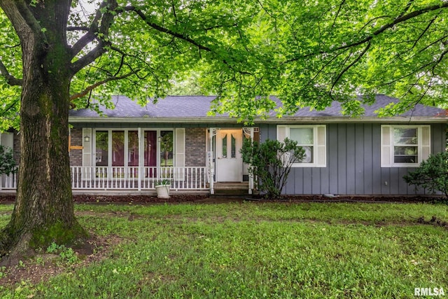 16777 Dublin St, West Frankfort, IL 62896 - ranch-style house featuring board and batten siding, a porch, a front lawn, and roof with shingles