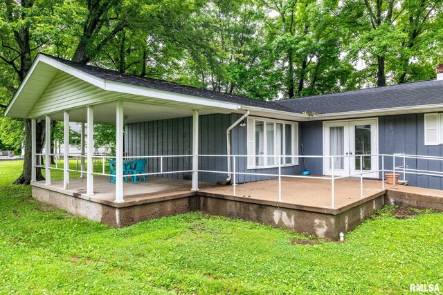 16777 Dublin St, West Frankfort, IL 62896 - rear view of property featuring french doors, board and batten siding, a lawn, and a patio