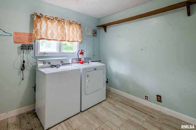 16777 Dublin St, West Frankfort, IL 62896 - washroom featuring a textured ceiling, washer and clothes dryer, and light wood-type flooring