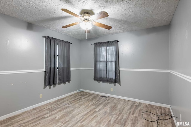 16777 Dublin St, West Frankfort, IL 62896 - empty room with wood finished floors, a textured ceiling, and ceiling fan