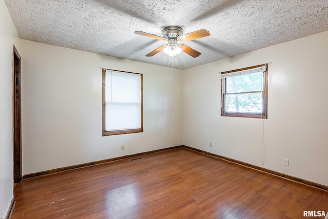 16777 Dublin St, West Frankfort, IL 62896 - unfurnished room with wood finished floors, a ceiling fan, and a textured ceiling