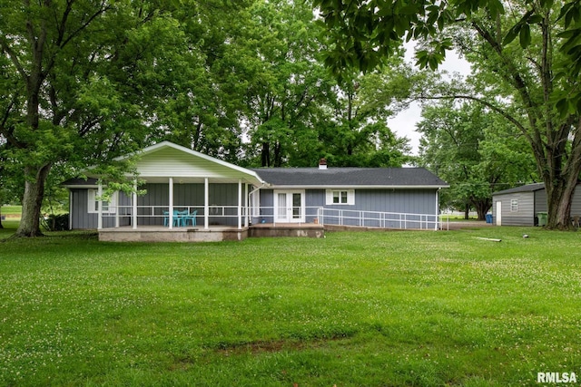 16777 Dublin St, West Frankfort, IL 62896 - back of property with a sunroom, a lawn, and a chimney