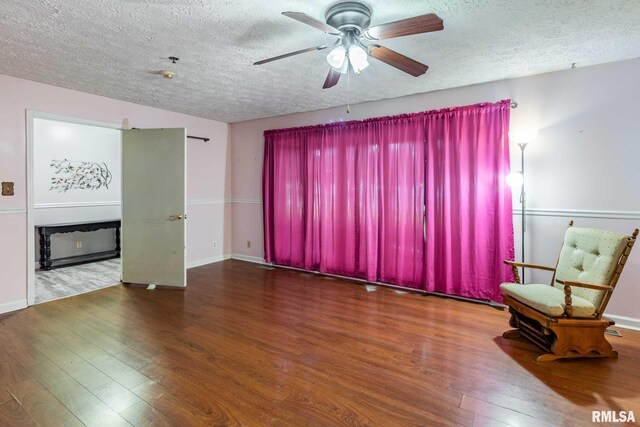 16777 Dublin St, West Frankfort, IL 62896 - living room featuring a textured ceiling, wood finished floors, and ceiling fan