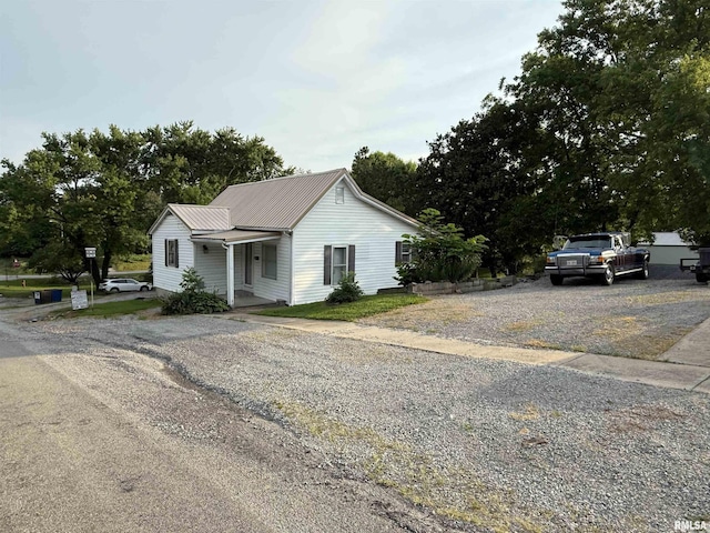 41 Cache Ave, Buncombe, IL 62912 - view of front facade with a metal roof and gravel driveway
