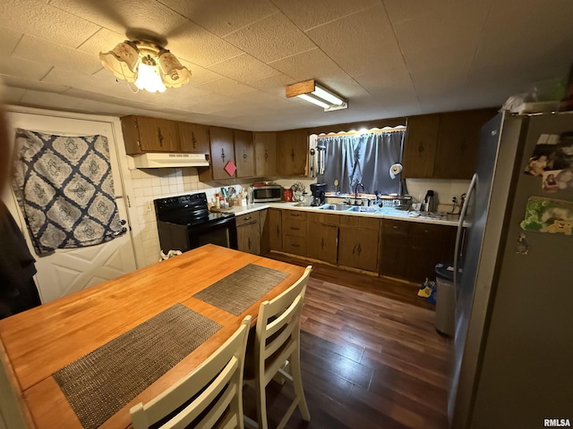 41 Cache Ave, Buncombe, IL 62912 - kitchen with appliances with stainless steel finishes, under cabinet range hood, dark wood-type flooring, and light countertops