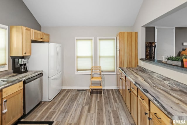 416 S Maple St, Salem, IL 62881 - kitchen featuring dishwasher, lofted ceiling, light wood-style flooring, stone counters, and freestanding refrigerator