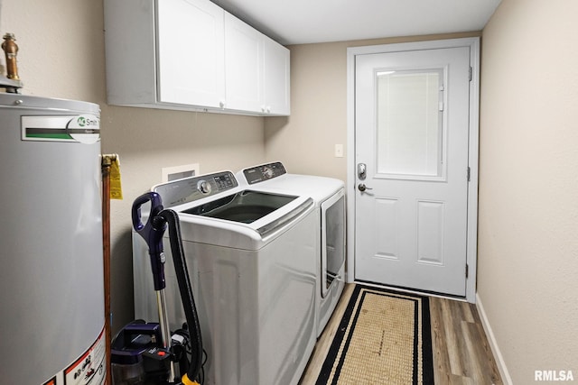 416 S Maple St, Salem, IL 62881 - washroom with water heater, washing machine and clothes dryer, cabinet space, and wood finished floors