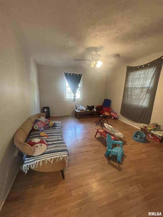 1112 Ophia St, Metropolis, IL 62960 - recreation room featuring a textured ceiling and wood finished floors