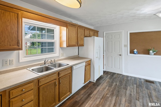 326 N Indiana St, Salem, IL 62881 - kitchen featuring white dishwasher, light countertops, dark wood finished floors, and brown cabinetry