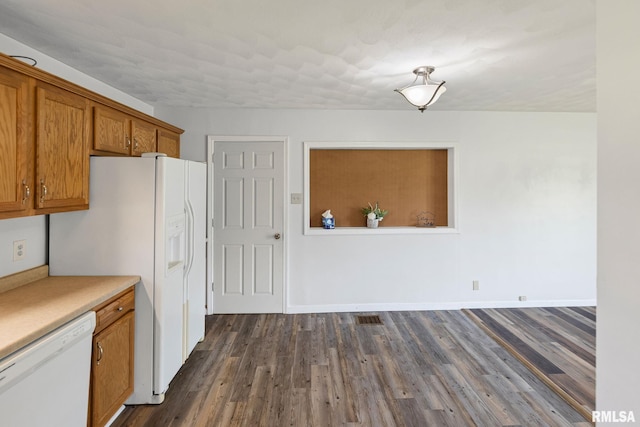 326 N Indiana St, Salem, IL 62881 - kitchen featuring white appliances, brown cabinets, dark wood-style flooring, and light countertops