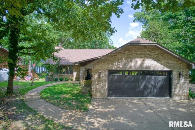 12299 Pebble Point Rd, Marion, IL 62959 - view of front of home featuring brick siding, concrete driveway, an attached garage, roof with shingles, and a front lawn