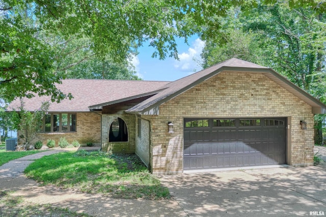 12299 Pebble Point Rd, Marion, IL 62959 - view of front of property featuring a garage, roof with shingles, driveway, and brick siding
