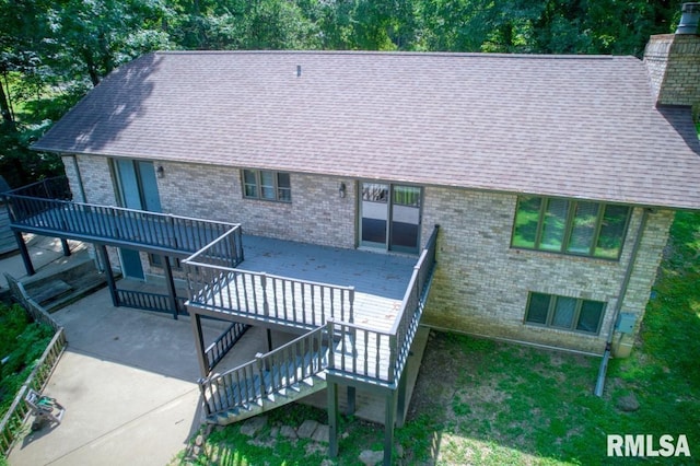 12299 Pebble Point Rd, Marion, IL 62959 - rear view of house with brick siding, a wooden deck, a patio, a shingled roof, and stairway