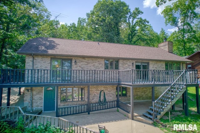 12299 Pebble Point Rd, Marion, IL 62959 - view of front of property with stairway, a wooden deck, brick siding, a chimney, and a patio