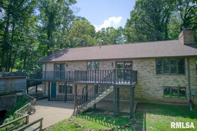 12299 Pebble Point Rd, Marion, IL 62959 - back of property featuring stairway, a patio, brick siding, a deck, and a shed
