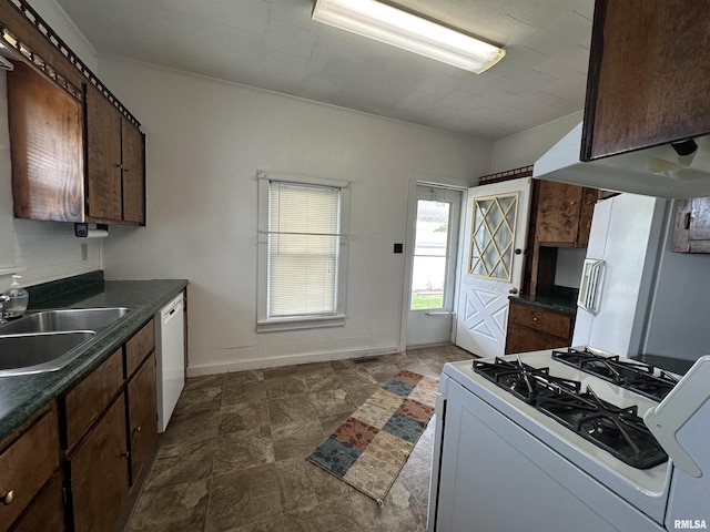 1520 Gartside St, Murphysboro, IL 62966 - kitchen with white appliances, dark countertops, stone finish flooring, and dark brown cabinets