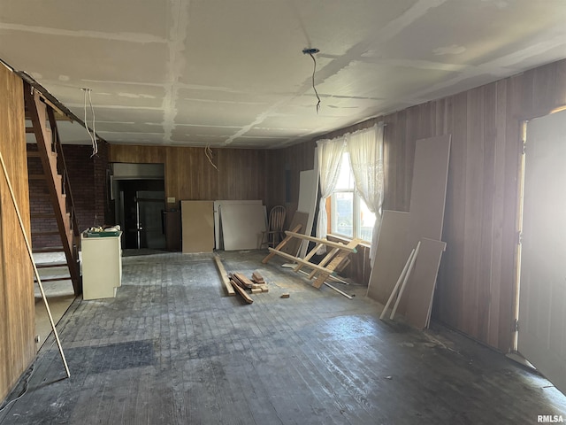 1420 W Cherry St, Herrin, IL 61948 - unfurnished room featuring wood-type flooring, wooden walls, and stairs