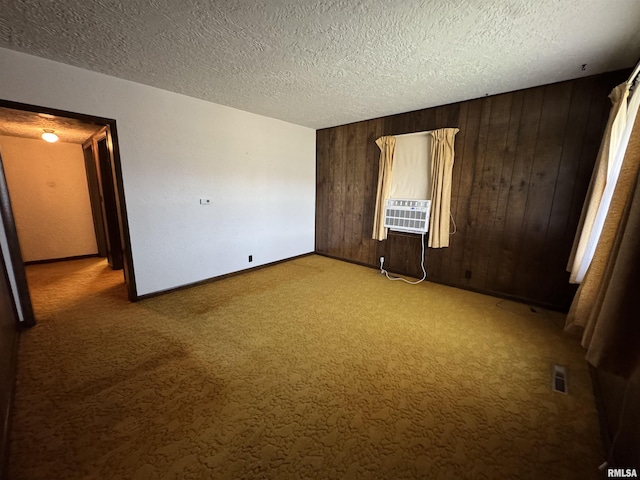 1607 W Cherry St, Marion, IL 62959 - unfurnished room with carpet, wooden walls, cooling unit, and a textured ceiling