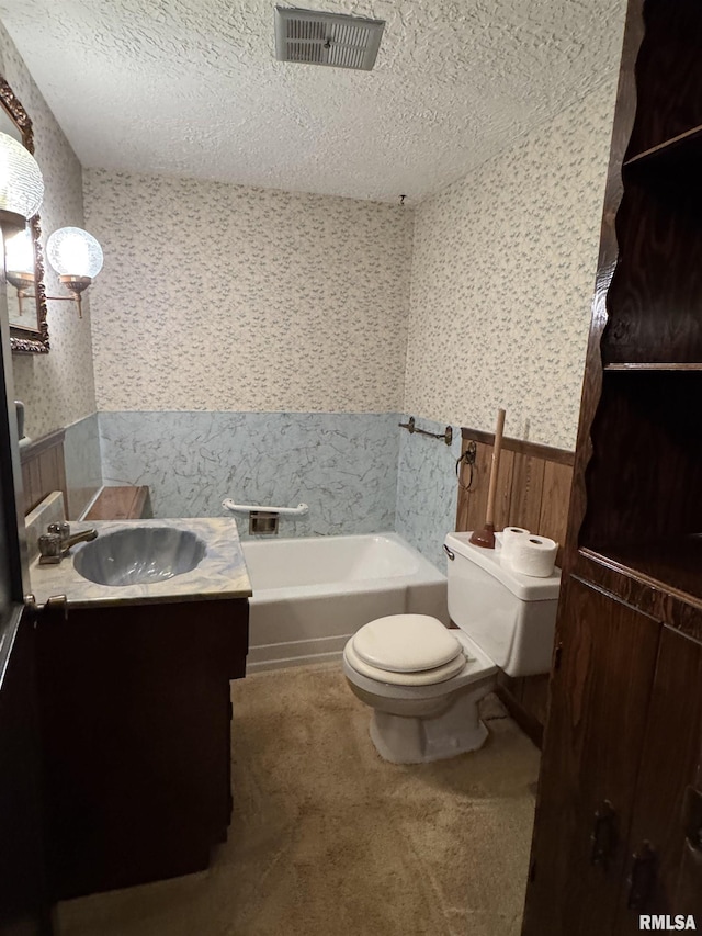 1607 W Cherry St, Marion, IL 62959 - bathroom featuring a wainscoted wall, wallpapered walls, a textured ceiling, a bath, and vanity